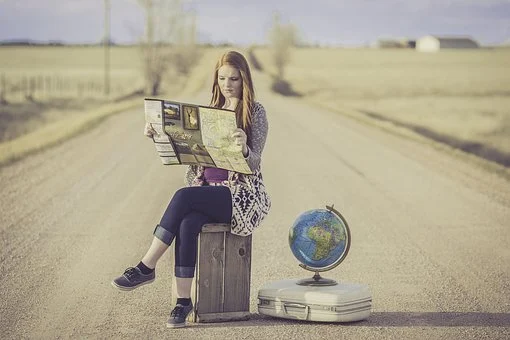 girl with globe and map for travel directions
