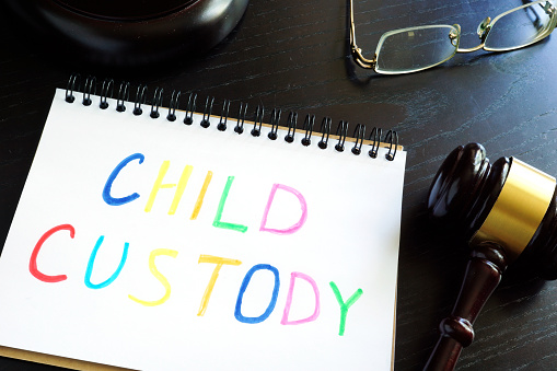 Child custody written in a note and gavel. Separation concept.
